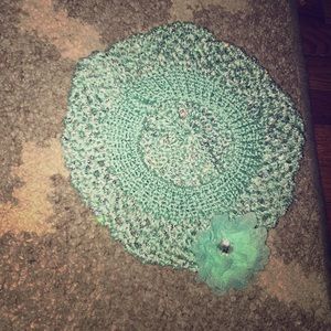 A justice beanie with a teal flower. It is sparkly